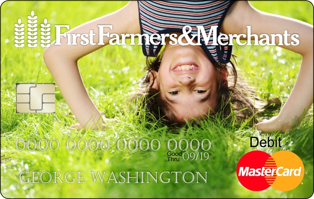 a debit card with a custom photo of a child standing on their head in the grass